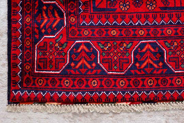 close up of a hand knotted small red khal mohammadi afghan rug