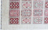 close up of hand knotted large pink white bakhtiari afghan rug