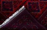 edge of a hand knotted medium dark red khal mohammadi afghan rug