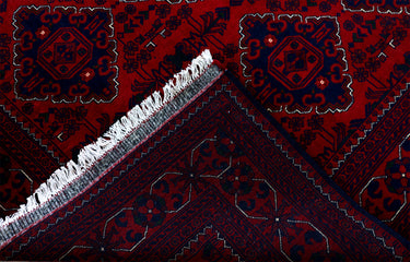 edge of a hand knotted medium dark red khal mohammadi afghan rug