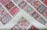 edge of hand knotted large pink white bakhtiari afghan rug