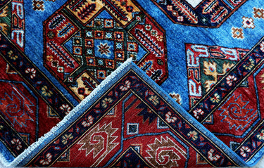 edge of hand knotted medium blue red kazak afghan rug